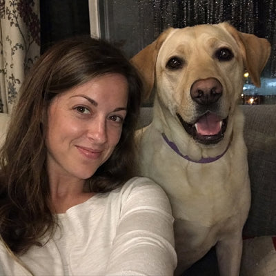 Sarah M. and Buster, her yellow Labrador in a purple CollarZen collar